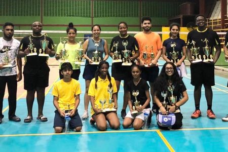  Participants of the 2019 West Indian Sports Complex Open doubles and under-19 singles badminton tournament pose with their spoils
