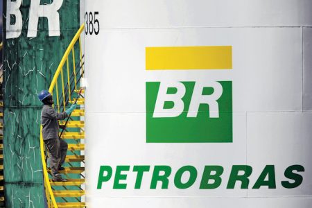 A worker paints a tank of Brazil’s state-run Petrobras oil company in Brasilia, Brazil September 30, 2015. Brazil’s state-run oil company Petroleo Brasileiro said on Tuesday it would raise the price of gasoline by 6 percent and diesel by 4 percent at refineries in Brazil. The change, Which will take effect on Sept. 30, comes to the firm struggles with mounting debt, falling oil prices and a giant corruption scandal. REUTERS/Ueslei Marcelino – GF10000227746