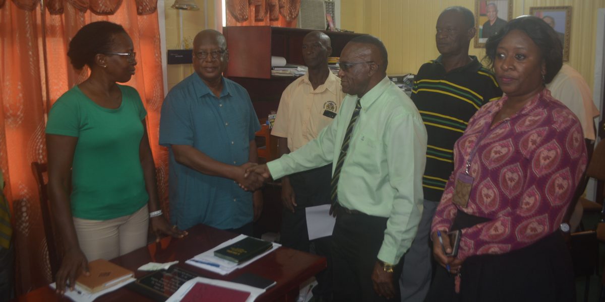 Managing Director of Kalibur Security, George Gomes (second from left) shaking the hands of Regional Chairman, Renis Morian while Region Ten Labour Officer Eleze Benjamin is at left in the presence of other officials. (Region Ten photo)