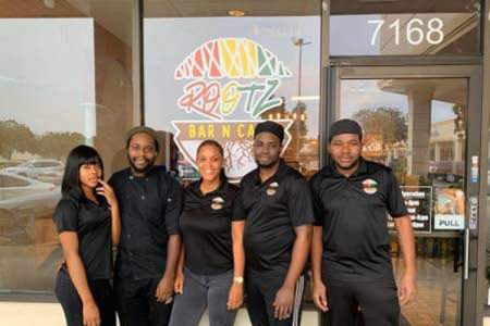 Chef Ade Ellis (second left) with some of his employees in front of his restaurant on North University Drive in Tamarac, Florida. (Photos: Mark Cummings)