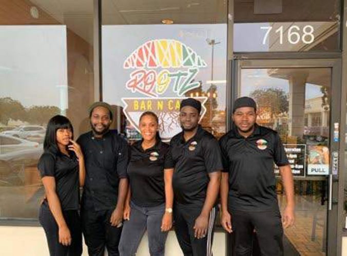 Chef Ade Ellis (second left) with some of his employees in front of his restaurant on North University Drive in Tamarac, Florida. (Photos: Mark Cummings)