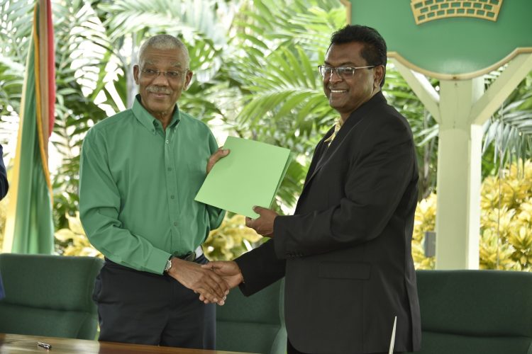 Chairman of APNU, President David Granger and Leader of the AFC Khemraj Ramjattan shaking hands on the revised accord.