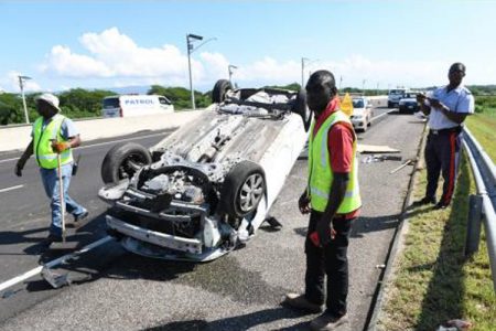 Highway 2000 staff and police on the scene of a motor vehicle accident on the East-West Highway near the Spanish Town toll plaza in St Catherine in November. The driver and passengers were taken to hospital.