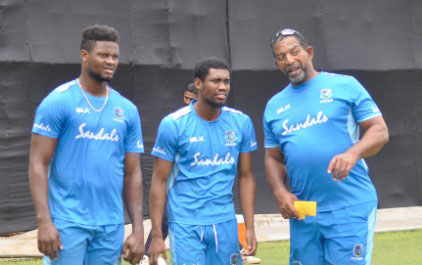 Head coach Phil Simmons (right) makes a point to Keemo Paul (centre) and Romario Shepherd during a training session. (CWI Media)