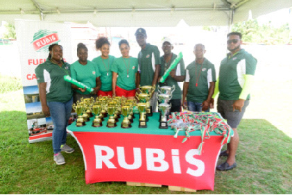 Members of Team RUBIS pose with officials from the Guyana Teachers’ Union with the trophies and medals that RUBIS donated to the event.