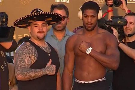 Champion John Ruiz Jr., with sombrero and challenger Anthony Joshua, at the weigh-in for today’s title rematch in Saudia Arabia. (Reuters photo)
