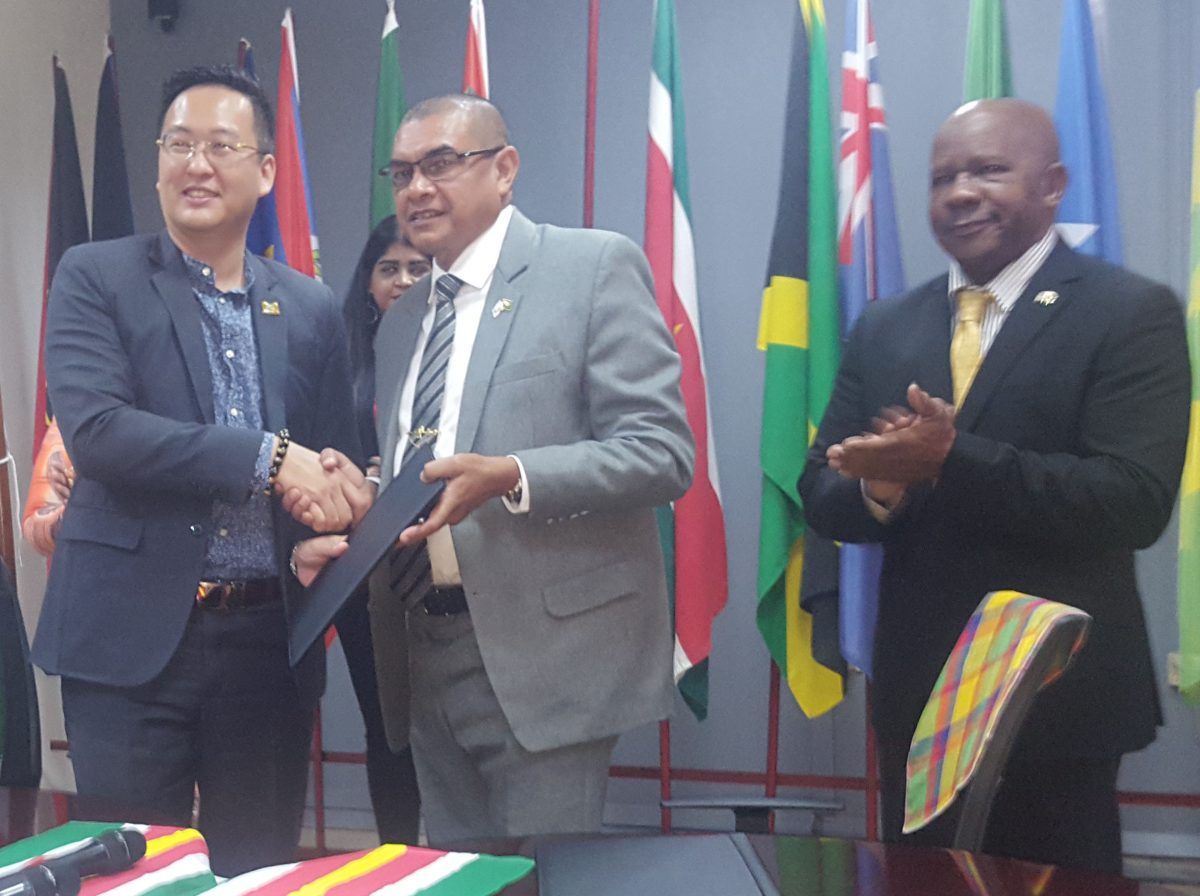 Minister of Trade, Tourism and Industry, Stephen Tsang (left) and Minister of Business, Haimraj Rajkumar shaking hands on the deal.