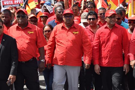 PPP/C presidential candidate Irfaan Ali (standing at centre) along with Prime Ministerial candidate, Brigadier (ret’d) Mark Phillips (first, from left) and General Secretary Bharrat Jagdeo (first, from right) as they led party supporters to the Umana Yana on Friday to present their lists of candidates. (PPP/C photo)