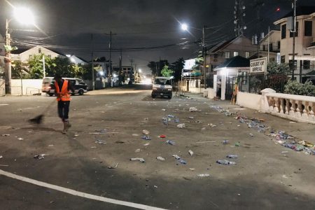 A city council worker cleaning up the environs of the Umana Yana on Friday evening in the aftermath of Nomination Day activities
