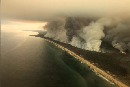 Thick plumes of smoke rise from bushfires at the coast of East Gippsland, Victoria, Australia yesterday. (Reuters photo)
