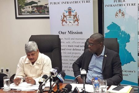 Minister within the Ministry of Public Infrastructure  Jaipaul Sharma (left) relays his account of monies expended by the Ministry of Public Infrastructure for 2019 as Minister of Public Infrastructure David Patterson looks on. 