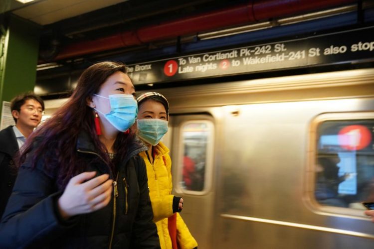 People wear surgical masks in the subway station at Times Square in New York, U.S., January 31, 2020. REUTERS/Bryan R Smith
