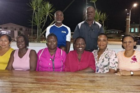 Re-elected President of Diamond United FC Orein Angoy [Standing left] posing with six of the women elected to serve as members of the executive committee. Also in the photo is EBFA President Kevin Anthony
