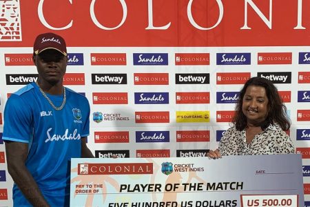 West Indies fast bowler Alzarri Joseph receives his Player-of-the-Match award.