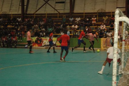 Action at the National Gymnasium between North East La Penitence [Red] and Avocado Ballers [Pink] in the Mashramani Cup Futsal Championships.
