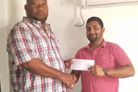 BCB President Hilbert Foster (left) receives sponsorship cheque from Devash Persaud, Marketing Manager of Nand Persaud Co. Ltd.
