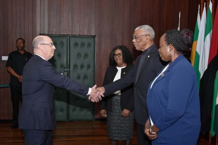 President David Granger (centre at right) exchanges a handshake with High Commissioner Bruce Lendon following the presentation of the Letters of Credence. Minister of Foreign Affairs, Dr. Karen Cummings and Permanent Secretary of the Ministry,  Charlene Phoenix (right in foreground) are also in the photograph. (Ministry of the Presidency photo)
