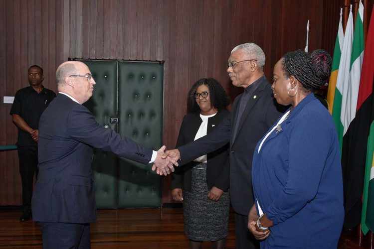 President David Granger (centre at right) exchanges a handshake with High Commissioner Bruce Lendon following the presentation of the Letters of Credence. Minister of Foreign Affairs, Dr. Karen Cummings and Permanent Secretary of the Ministry,  Charlene Phoenix (right in foreground) are also in the photograph. (Ministry of the Presidency photo)
