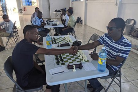 Champions shake hands! Anthony Drayton (left) and Wendell Meusa shake hands before the commencement of an encounter at the National Aquatic Centre during a Gaico Construction Grand Prix chess tournament in 2019. Drayton has already secured a place in the 2020 national chess championship, owing to the fact he is last year’s national champion. However, Meusa will be among the principal contenders vying for a place in the competitive 2020 national qualifier tournament. Meusa is a former national chess champion.
