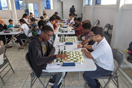 Jaden Taylor of St Stanislaus College (left) and Queens College’s Rajiv Lee locked in battle during a junior competition at the National Aquatic Centre in 2019. The two were, perhaps, the more enterprising junior chess players of the past year. Let us see what will happen in the 2020 National Chess Qualifiers where it will be every man for himself. The prize? Ten participants will qualify to play the National Chess Championship. Can a junior qualify?  (Photo by John Lee)