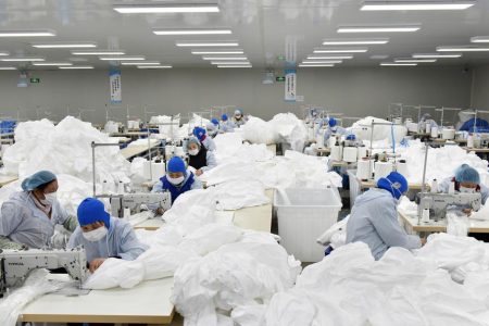 Workers make protective suits at a factory, as the country is hit by an epidemic of the new coronavirus, in Chaohu, Anhui province, China January 28, 2020. China Daily via REUTERS