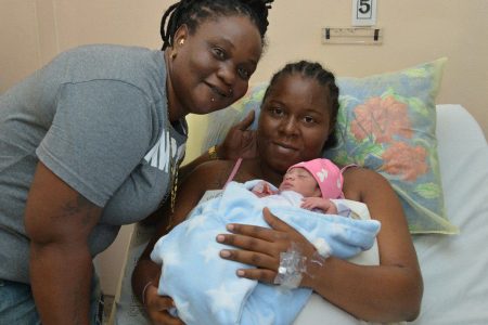 A 2020 FAMILY: Shaciba St Louis, right, and her girlfriend Lisa Melville hold their daughter Miracle, who was the fourth baby delivered for 2020 at the Mt Hope Women’s Hospital, Mt Hope, yesterday. Miracle, whose weight was five pounds, three ounces, was born at 6.03 a.m.  