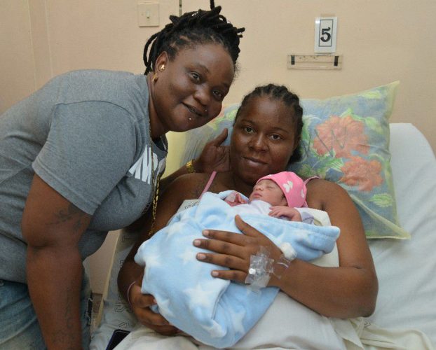 A 2020 FAMILY: Shaciba St Louis, right, and her girlfriend Lisa Melville hold their daughter Miracle, who was the fourth baby delivered for 2020 at the Mt Hope Women’s Hospital, Mt Hope, yesterday. Miracle, whose weight was five pounds, three ounces, was born at 6.03 a.m.  