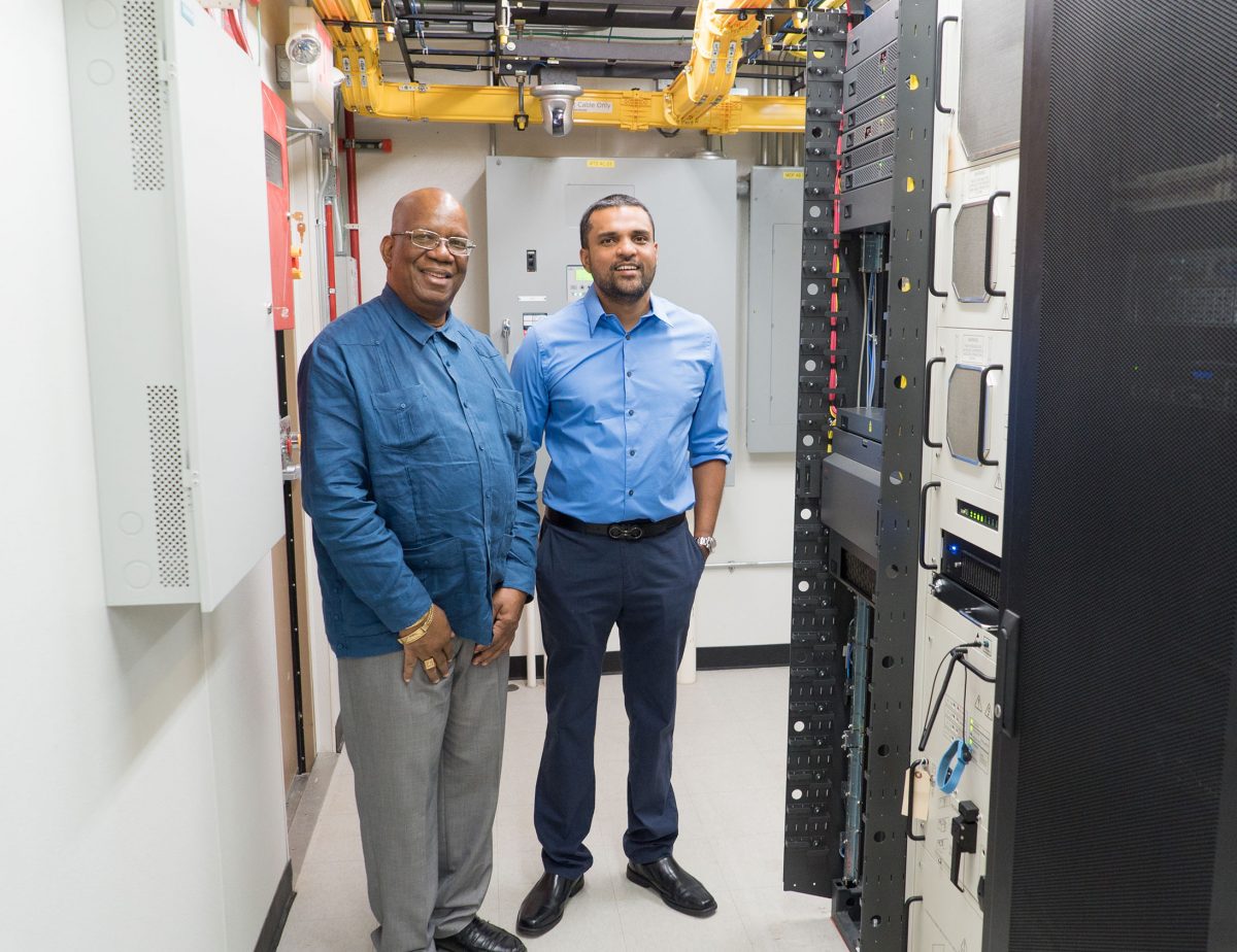 Minister of Finance Winston Jordan (left) and   Managing Director  of E-Networks Vishok Persaud during the tour. (Ministry of Finance photo)