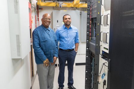Minister of Finance Winston Jordan (left) and   Managing Director  of E-Networks Vishok Persaud during the tour. (Ministry of Finance photo)