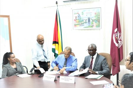 The MOU being signed.  The head of NANA, Michael Atherly is third from left and the head of the FIU Matthew Langevine is fourth from left. (NANA photo)