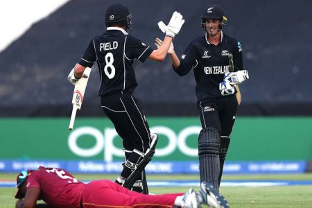 Kristian Clarke and Joey Field leave the field in
triumph and the Young Windies crestfallen after their ninth wicket heroics saw New Zealand to the semi-finals.
