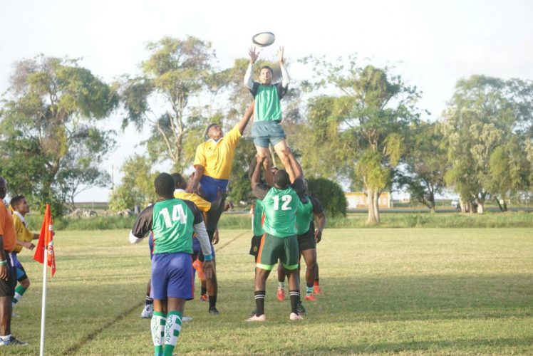 The green clad side (right) wins a line-out against the men in yellow yesterday. However the latter got the better of the former 13-7, following the scrimmage at the National Park. (Emmerson Campbell photo)