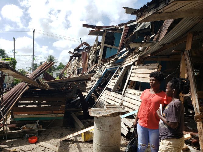 Wanda La Rose in front of the collapsed building where her cousin resided