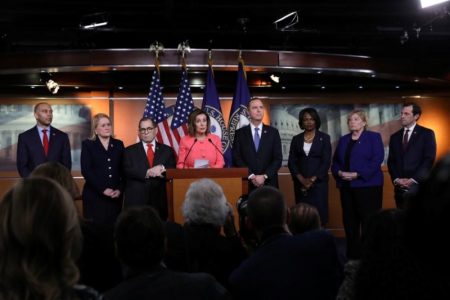 Nancy Pelosi (centre) making the announcement today (Reuters/Leah Mills)