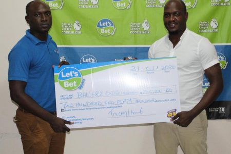 Let’s Bet Sports Brand Ambassador Rawle Toney [left] hands over the sponsorship cheque to Ballers Entertainment PRO Clayton Reece.
