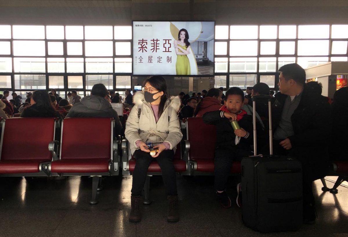 A woman wearing a mask is seen at a waiting area for a train to Wuhan at the Beijing West Railway Station, ahead of Chinese Lunar New Year, in Beijing, China January 20, 2020. REUTERS/Stringer