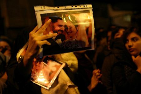 A woman holds a picture of newlyweds, victims of the crash of the Boeing 737-800 plane, flight PS 752, as people gather to show their sympathy in Tehran, Iran January 11, 2020. Nazanin Tabatabaee/WANA (West Asia News Agency) via REUTERS /File Photo