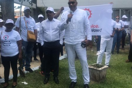 Nigel Hinds on Friday addressing supporters prior to Change Guyana submitting its lists of candidates. Also in photo at left is presidential candidate Robert Badal.