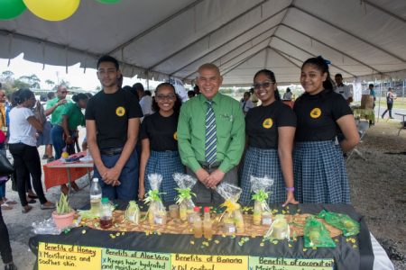 Dr. George Norton, Minister of Social Cohesion alongside students of North Georgetown Secondary School. (DPI photo)