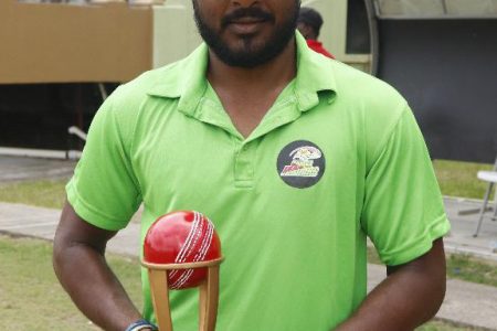 Veerasammy Permaul poses with his accolade presented to him by the Guyana Cricket Board for his services (Romario Samaroo photo)