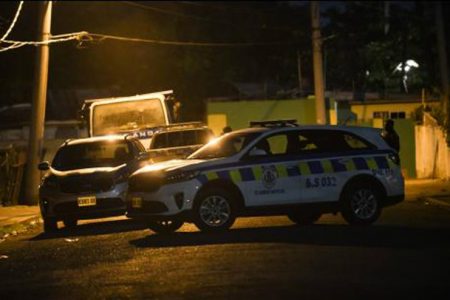 A police service vehicle blocks access along Bowens Road, in the vicinity of Waltham Park Road, where six people were hit in a drive-by shooting around 6:30 p.m. Up to press time, one woman was pronounced dead.