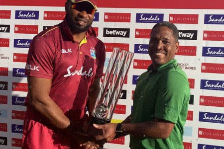 West Indies captain Kieron Pollard receives the winning series trophy.

