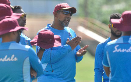 Head coach Phil Simmons (centre) makes a point to his players during a training session yesterday. (Photo courtesy CWI Media) 