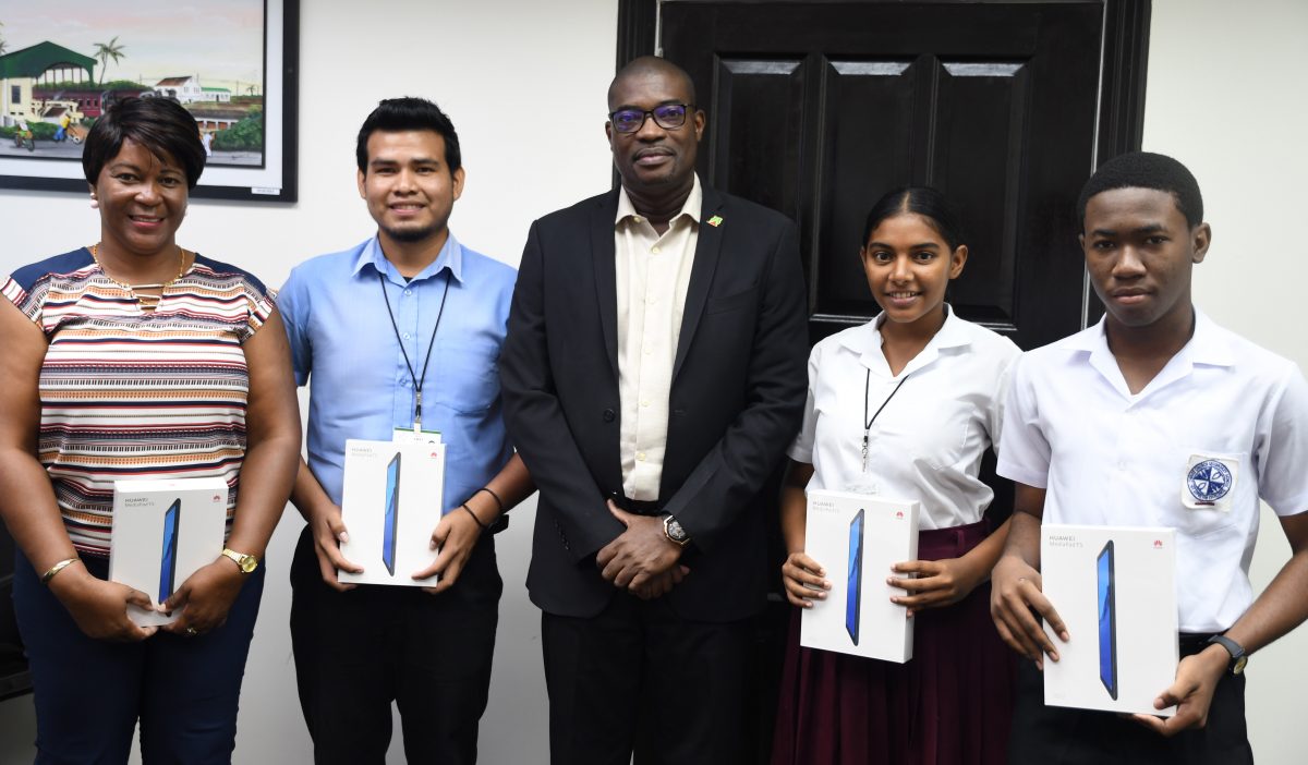 From left: CORE Group Project Coordinator, Charlene Garraway; GTI student, Dishon John; Minister of Public Infrastructure David Patterson, Amisha Deonarine and Ethan Seymore.