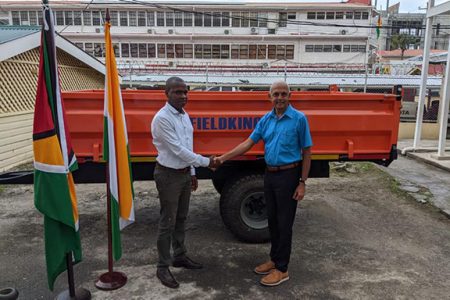 Minister of Communities Ronald Bulkan (right)  hands over the trailers to Mayor of Bartica,  Gifford Marshall. (DPI photo)
