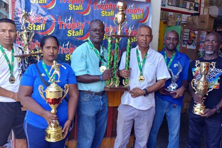 Trophy Stall’s Ramesh Sunich, third from right and EBFA’s Kevin Anthony display the trophies. 