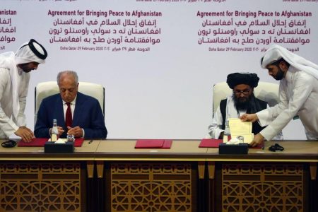 The deal was signed in the Qatari capital Doha by U.S. special envoy Zalmay Khalilzad (seated at left) and Taliban political chief Mullah Abdul Ghani Baradar. (Reuters photo)