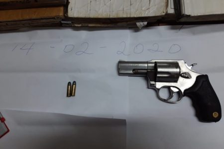 The unlicensed pistol and ammunition that were found in the parcel. (Guyana Police Force photo)
