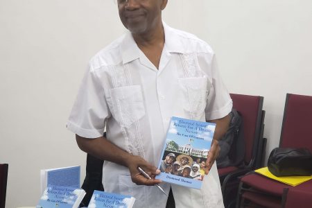 Economist Dr Desmond Thomas with his new book 