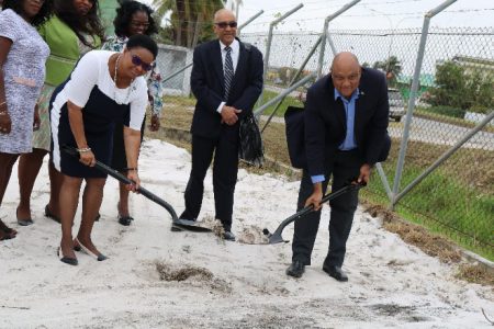 Minister of Natural Resources Raphael Trotman (right) and Minister of Public Health, Volda Lawrence turning the sod.